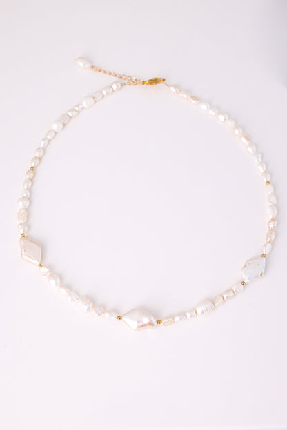 שרשרת SHAI פניני בארוק, מונחת שטוח על לבן. משולבות 3 פנינים שטוחות, חרוזי זהב וסוגר מוזהב.