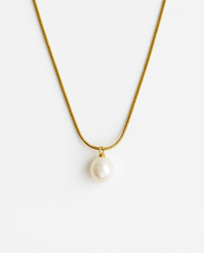 שרשרת ALUR זהב, שרשרת נחש עדינה עם תליון פנינה עגולה בוהקת, מצולמת על רקע לבן.